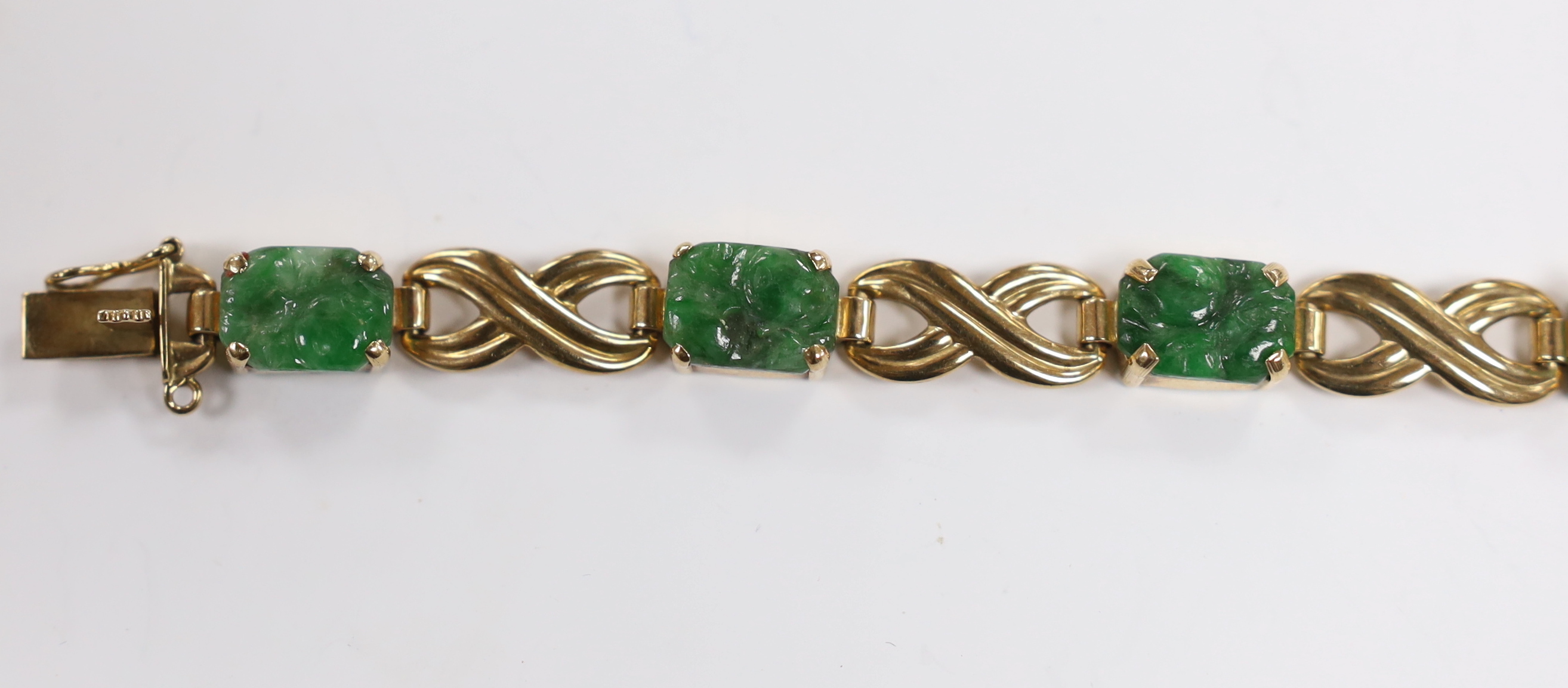A 1960's 9ct gold and six stone carved jade panel set bracelet, by Cropp & Farr,17cm, gross weight 15.2 grams.